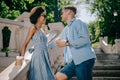 side view of stylish multicultural couple with coffee cups standing