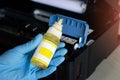 Side view of technician filling printer with ink Royalty Free Stock Photo