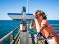 Boy is looking through a binocular at the sea Royalty Free Stock Photo