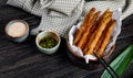 side view of tempura vegetables in a bowl served with soy sauce on wooden background with plaid fabric Royalty Free Stock Photo