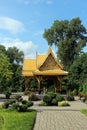 A side view of the Thai Pavilion surrounded by trees, shrubs and flowers at Olbrich Botanical Gardens in Wisconsin