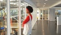 Thoughtful Businesswoman standing with arms crossed in office Royalty Free Stock Photo