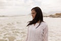 thoughtful young woman standing on beach Royalty Free Stock Photo