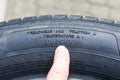 Side view of tire with tire traction rating, treadwear index and tire outside designation Royalty Free Stock Photo