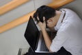 Side view of tired confused young Asian business man cover face with his hands Royalty Free Stock Photo