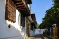 Side view to historic buildings in the Palace of Inquisition with artful woodwork and white facades, Cartagena, Unesco World