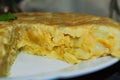 Side view of a tortilla de patatas sliced, you can see the interior of it