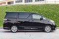 Side View of Toyota Vellfire japanese luxury minivan car in black color on the parking with seven passenger seats Royalty Free Stock Photo