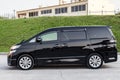 Side View of Toyota Vellfire japanese luxury minivan car in black color on the parking with seven passenger seats Royalty Free Stock Photo