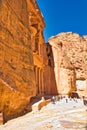 Side view of the treasury in Petra, Wadi Musa in Jordan, with tourists in front of the majestic architecture