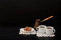 Side view of two cups of coffee on the lace napkins, chocolate dessert and Turkish pots Royalty Free Stock Photo