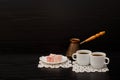 Side view of two cups of coffee on the lace napkins, Turkish dessert and pots Royalty Free Stock Photo