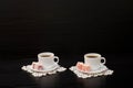 Side view of two cups of coffee on the lace napkins, Turkish dessert. Space for text Royalty Free Stock Photo