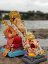 Side view of two ganpati idols ganpati visarjan in river. Royalty Free Stock Photo