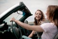 Side view.two girlfriends enjoying a ride in the car Royalty Free Stock Photo