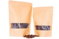 Side view of two kraft paper doypack stand up pouches with window and zipper filled with coffee beans on white background Royalty Free Stock Photo