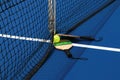 Side view of two pickleball paddles and one yellow whiffle ball on a blue court