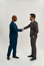 Side view of two smiling businessmen shaking hands Royalty Free Stock Photo