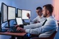 Side view. Two stock traders working in the office with exchange technology Royalty Free Stock Photo