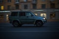 Side view of UAZ Patriot car drive on high speed. Driving SUV auto at night on city road. Blured car motion in evening Royalty Free Stock Photo