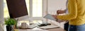 Side view of UI developer team consulting on their project with mock-up tablet at workspace Royalty Free Stock Photo