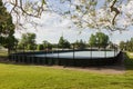 Side view of an unoccupied roller hockey rink in a city park Royalty Free Stock Photo