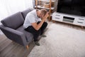 Upset Man Sitting On Sofa Royalty Free Stock Photo