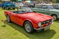 Classic Triumph TR6 convertible sports car on display at a public car show