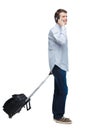 Side view of walking business man with suitcase talking on the phone Royalty Free Stock Photo