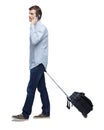 Side view of walking business man with suitcase talking on the phone Royalty Free Stock Photo