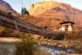 side view of walking suspension bridge with a lot of colorful prayer flags in Bhutan