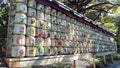 Side view of a wall of sake barrels, Japanese rice wine, on display along the South Approach of Meiji Shrine