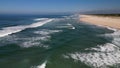 Side view of waves crashing on sandy beach Royalty Free Stock Photo