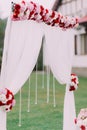 Side view of the wedding arch decorated with colourful flowers and hanging beads. Royalty Free Stock Photo