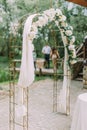 The side view of the wedding arch decorated with white flowers. Royalty Free Stock Photo