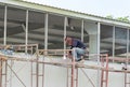 Side view of welder is welding the window