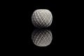 Side view of white ball of string on black background Royalty Free Stock Photo