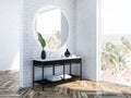 White brick bathroom corner, round mirror Royalty Free Stock Photo