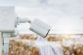 Side view of white CCTV security camera video system for safety at a paper recycling factory. Closed-circuit television. CCTV Royalty Free Stock Photo