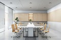 Side view on white glossy meeting table and wheel chairs in minimalistic style conference room with transparent doors, concrete
