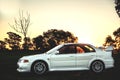 Side view of a white Mitsubishi Evolution VI