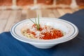 Side view of white plate of spaghetti bolognese with tomato sauce, meat and cheese Royalty Free Stock Photo