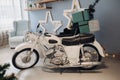 Cool retro motorcycle with Christmas presents. Motorcycle with gifts in decorated room. Royalty Free Stock Photo