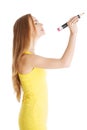 Side view of a woman with big crayon writing