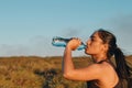 Side view of woman drinking water after sport activities. Copy space Royalty Free Stock Photo