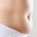 Side view of woman with fat belly. Obesity concept. Royalty Free Stock Photo