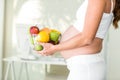 Side view of woman holding fruit bowl Royalty Free Stock Photo