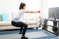 Woman going squats at home Royalty Free Stock Photo