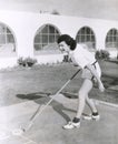 Side view of woman playing shuffleboard Royalty Free Stock Photo