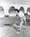 Side view of woman playing shuffleboard Royalty Free Stock Photo